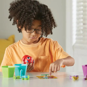 Grab that Monster Fine Motor Game. Educational Toy. Child using the spinner.