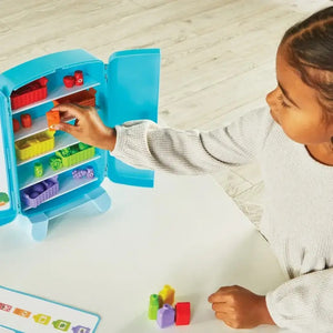 Learning Resources Sorting Snacks Mini Fridge Educational Toys. Child filling fridge.