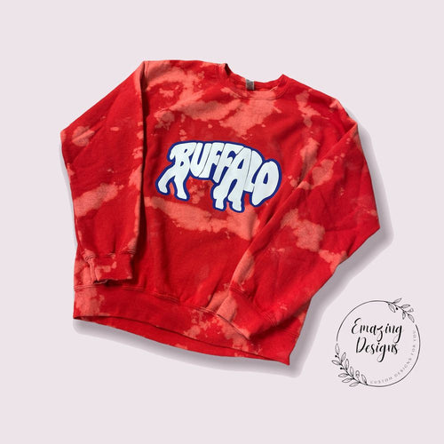 Red Bleach Dyed crewneck sweatshirt with royal blue & white Buffalo lettering in shape of buffalo on front.