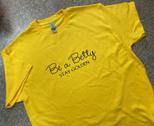 Load image into Gallery viewer, Yellow adult size Be a Betty Stay Golden in black sparkle lettering tshirt