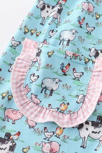 Teal white collar with pink gingham trim farm print dress for kids close up of ruffle pocket
