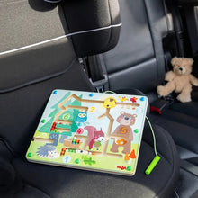 Load image into Gallery viewer, HABA Magnetic Maze Forest Friends Travel Toy in car.